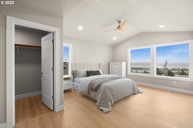 35505 Upper Loop Rd, Pacific City, OR 97135 - bedroom with light wood finished floors, lofted ceiling, baseboards, a spacious closet, and ceiling fan