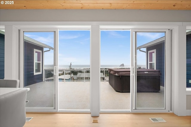 35505 Upper Loop Rd, Pacific City, OR 97135 - doorway to outside with healthy amount of natural light and wood finished floors