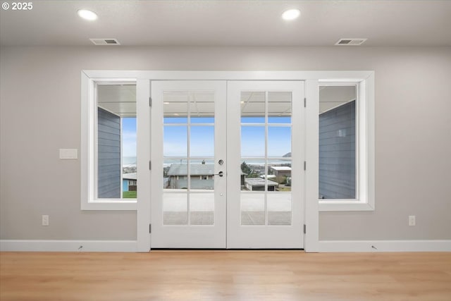 35505 Upper Loop Rd, Pacific City, OR 97135 - doorway with french doors, light wood finished floors, recessed lighting, baseboards, and healthy amount of natural light