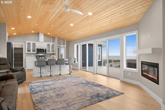 35505 Upper Loop Rd, Pacific City, OR 97135 - living area with lofted ceiling, wood ceiling, baseboards, light wood-style floors, and recessed lighting
