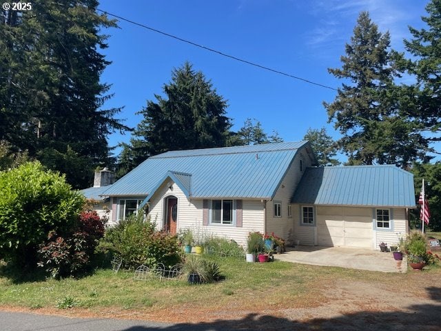 53742 Rosa Rd, Bandon, OR 97411 - back of property featuring a garage, driveway, and metal roof