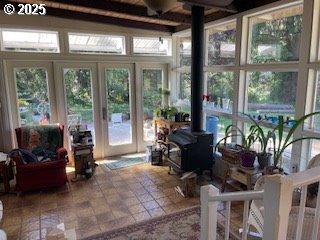 53742 Rosa Rd, Bandon, OR 97411 - sunroom with a wood stove and beam ceiling