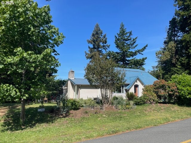 53742 Rosa Rd, Bandon, OR 97411 - view of front facade with a chimney and a front yard