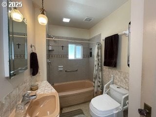 53742 Rosa Rd, Bandon, OR 97411 - bathroom with tile walls, toilet, shower / tub combo with curtain, and a sink