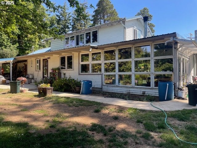 53742 Rosa Rd, Bandon, OR 97411 - rear view of house featuring a sunroom and a patio
