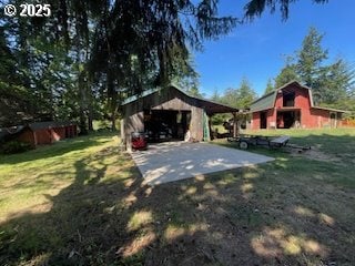 53742 Rosa Rd, Bandon, OR 97411 - view of green lawn featuring an outdoor structure and a barn