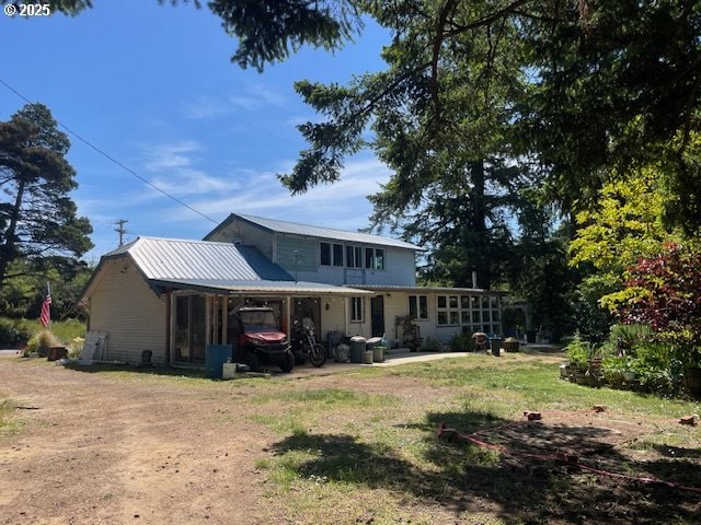 53742 Rosa Rd, Bandon, OR 97411 - rear view of house with a yard and a sunroom