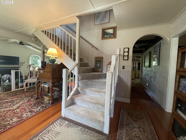 53742 Rosa Rd, Bandon, OR 97411 - stairway featuring wood finished floors, ceiling fan, ornamental molding, and arched walkways