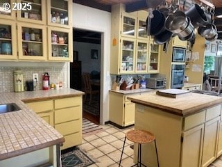 53742 Rosa Rd, Bandon, OR 97411 - kitchen with light countertops, decorative backsplash, and appliances with stainless steel finishes