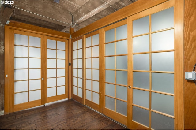 empty room with dark wood-type flooring and french doors