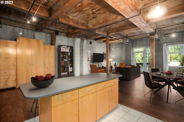 kitchen featuring beamed ceiling, light brown cabinetry, light tile patterned floors, and wooden ceiling