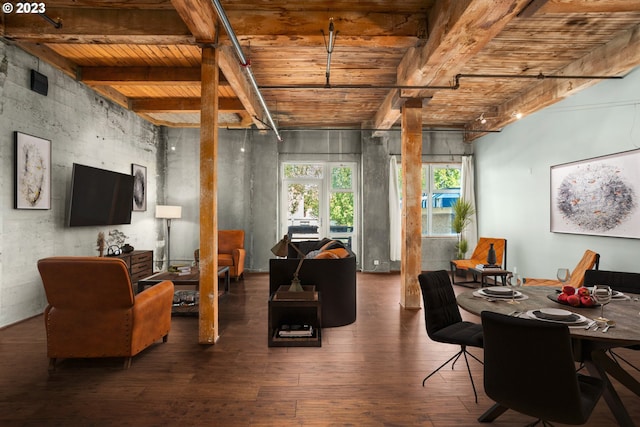 interior space featuring dark hardwood / wood-style flooring, beamed ceiling, and track lighting