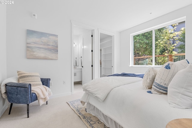 bedroom with carpet flooring and connected bathroom