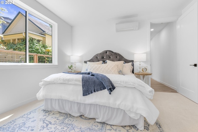 carpeted bedroom featuring a wall unit AC