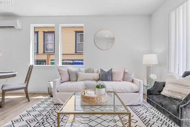 living room featuring an AC wall unit and light hardwood / wood-style flooring