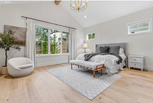 bedroom featuring a chandelier, beam ceiling, wood finished floors, baseboards, and high vaulted ceiling