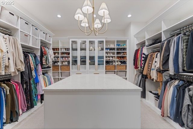 spacious closet featuring a chandelier