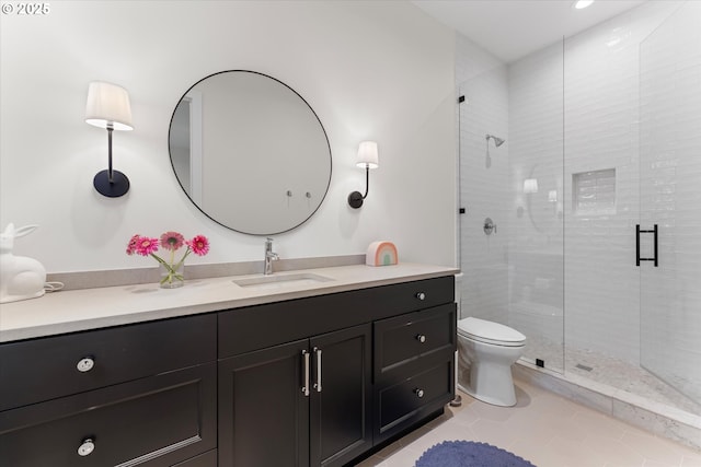 full bathroom featuring vanity, a shower stall, tile patterned floors, and toilet