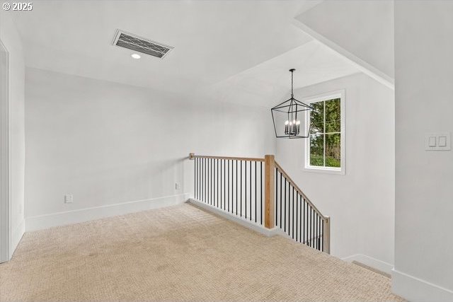 stairs featuring carpet, a chandelier, baseboards, and lofted ceiling
