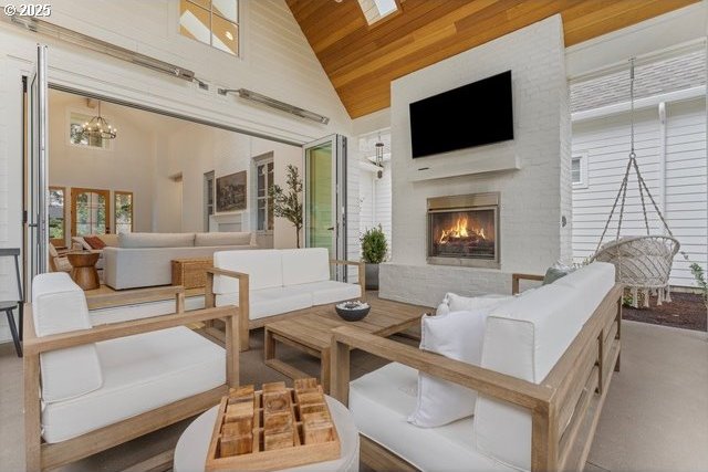 view of patio / terrace with an outdoor living space with a fireplace