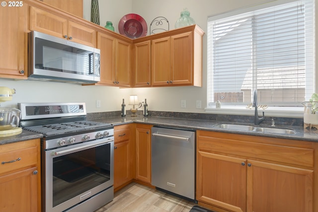 1281 Alderdale Dr, Junction City, OR 97448 - kitchen featuring appliances with stainless steel finishes, a sink, light wood-style floors, and healthy amount of natural light