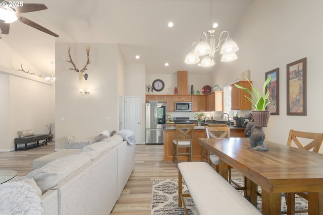 1281 Alderdale Dr, Junction City, OR 97448 - dining room featuring high vaulted ceiling, a chandelier, light wood-style flooring, ceiling fan, and recessed lighting