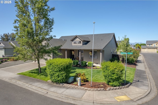 1281 Alderdale Dr, Junction City, OR 97448 - view of front of house featuring a front yard, concrete driveway, a garage, and roof with shingles