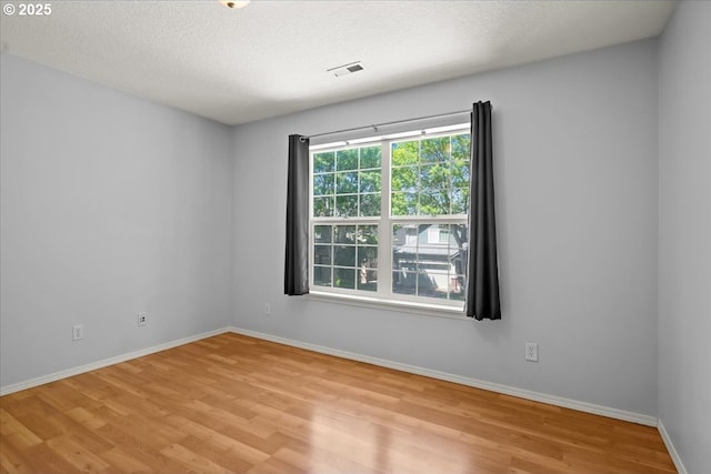 5836 NE Farnham St, Hillsboro, OR 97124 - spare room featuring light wood-style floors, baseboards, and a textured ceiling