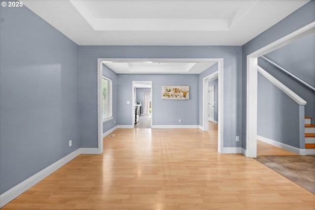 5836 NE Farnham St, Hillsboro, OR 97124 - empty room with a tray ceiling, light wood-type flooring, stairway, and baseboards