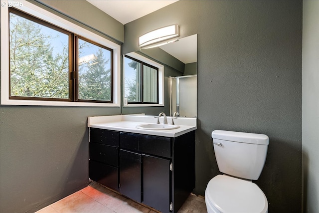 bathroom with vanity, toilet, and tile patterned flooring