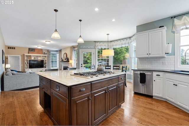 kitchen with visible vents, white cabinetry, appliances with stainless steel finishes, and a wealth of natural light