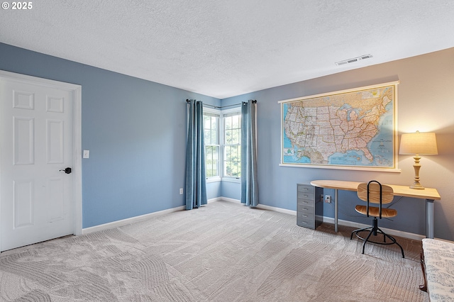 office area with visible vents, a textured ceiling, baseboards, and carpet