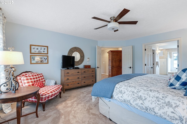 bedroom with light carpet, a ceiling fan, and a textured ceiling