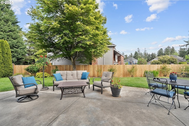 view of patio with an outdoor living space, outdoor dining area, and a fenced backyard