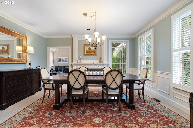 dining space with visible vents, carpet flooring, crown molding, and a chandelier