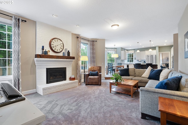 carpeted living area featuring baseboards, a brick fireplace, and recessed lighting