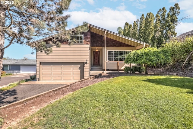 view of front of house with a garage, a front lawn, driveway, and covered porch