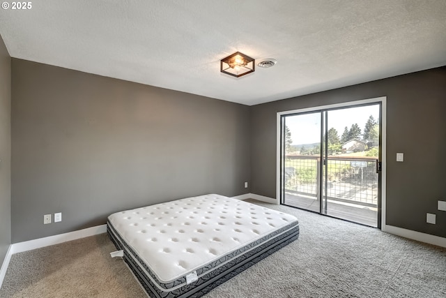 bedroom with baseboards, access to outside, carpet, and a textured ceiling