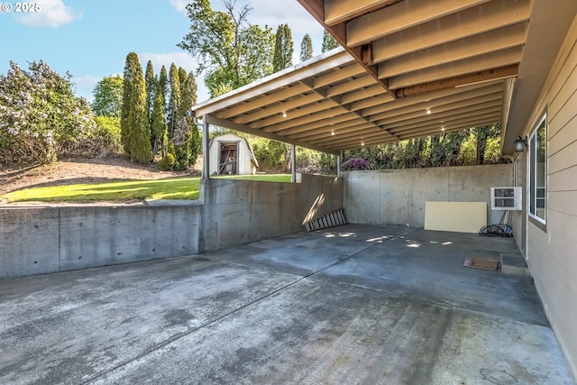 view of patio with an outbuilding, a storage shed, and a carport