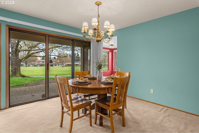 dining area featuring a wealth of natural light, a textured ceiling, a chandelier, and carpet floors