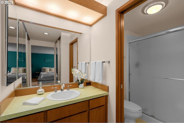 full bath featuring a shower stall, ensuite bathroom, vanity, and toilet