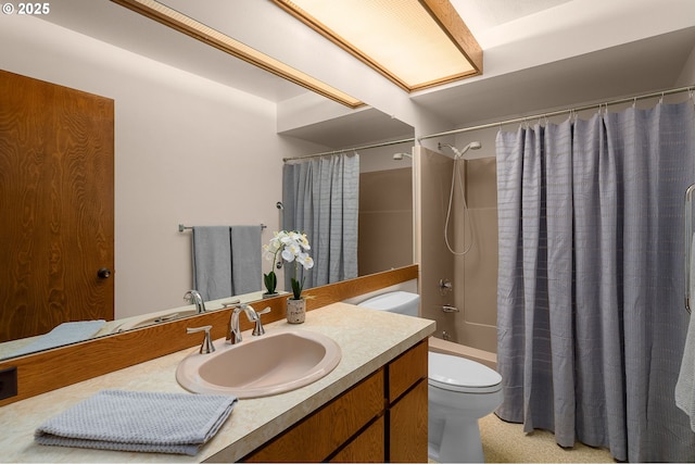 bathroom featuring toilet, shower / tub combo with curtain, and vanity
