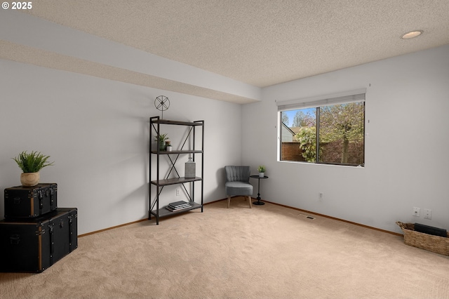 unfurnished room featuring baseboards, carpet flooring, and a textured ceiling