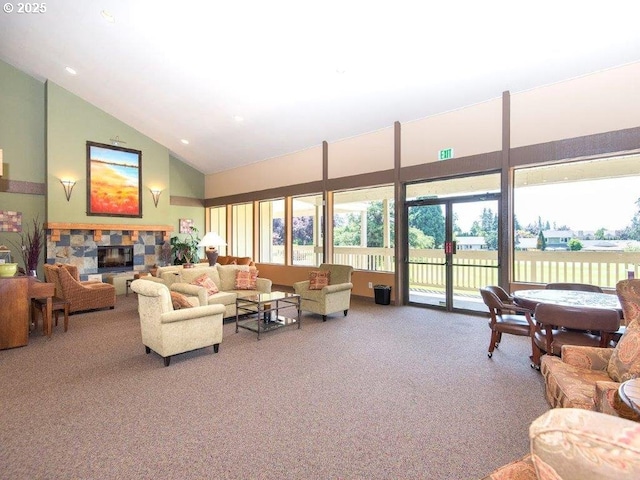 living room featuring high vaulted ceiling, carpet flooring, and a stone fireplace