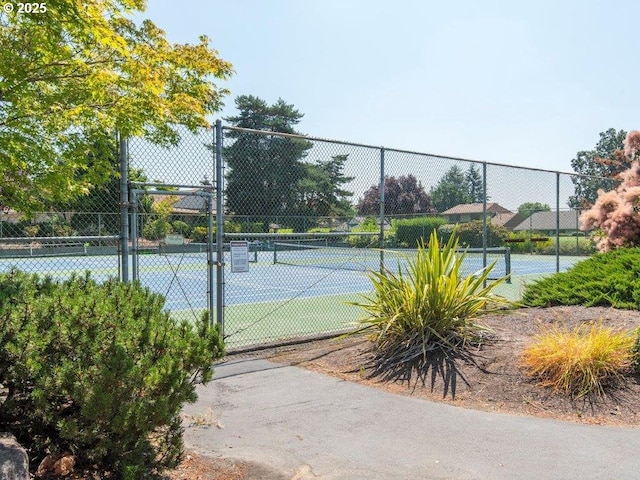 view of tennis court featuring fence
