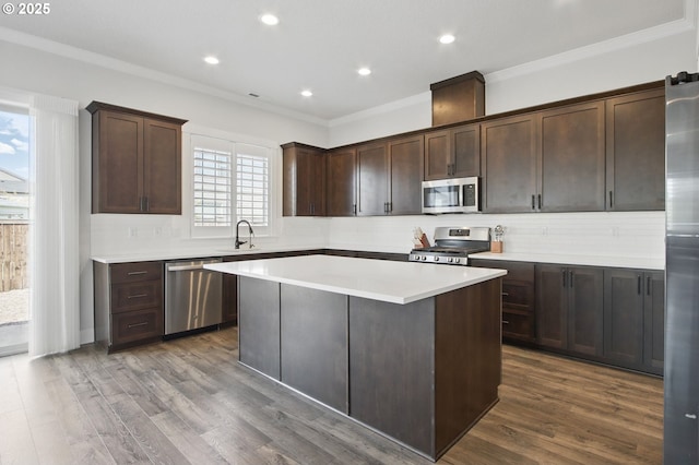 29169 NW King St, North Plains, OR 97133 - kitchen featuring crown molding, tasteful backsplash, dark brown cabinets, and stainless steel appliances