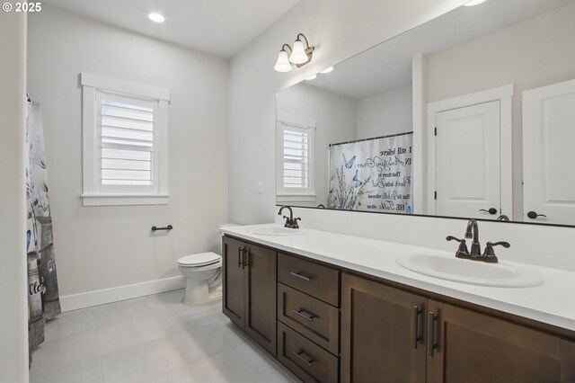29169 NW King St, North Plains, OR 97133 - bathroom with a sink, baseboards, toilet, and double vanity