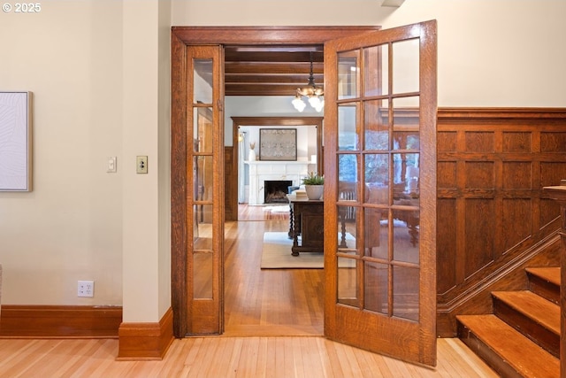 1314 SE 55th Ave, Portland, OR 97215 - corridor featuring wood finished floors, beam ceiling, french doors, and baseboards
