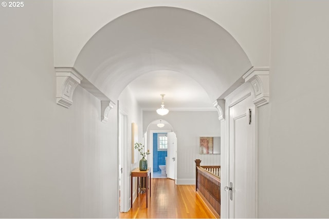 1314 SE 55th Ave, Portland, OR 97215 - hall featuring arched walkways, light wood-style flooring, and ornate columns