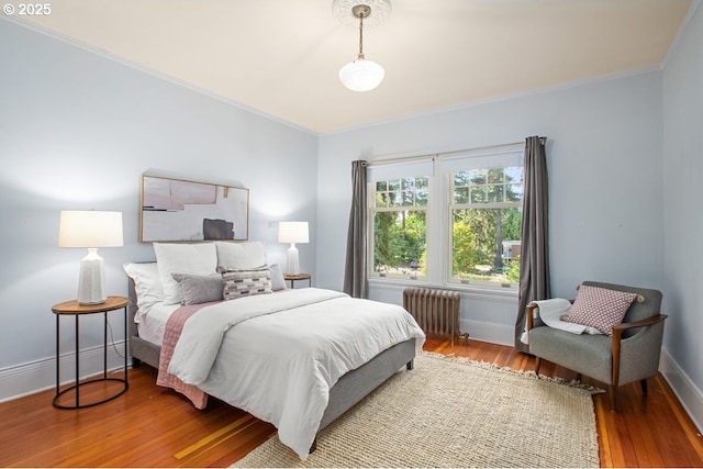 1314 SE 55th Ave, Portland, OR 97215 - bedroom featuring radiator heating unit, ornamental molding, wood finished floors, and baseboards